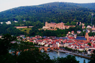 High angle view of townscape by river in town