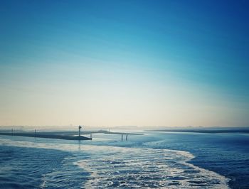 Scenic view of sea against clear blue sky