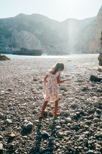 Rear view of woman walking on beach