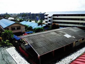 High angle view of houses by swimming pool against sky