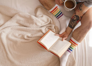 High angle view of coffee cup on book