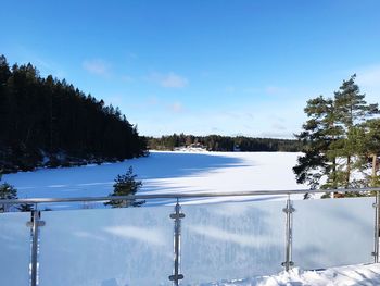 Scenic view of snow covered trees against blue sky