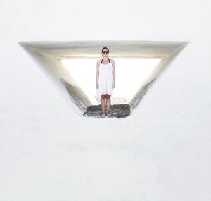 Woman standing in window of white wall