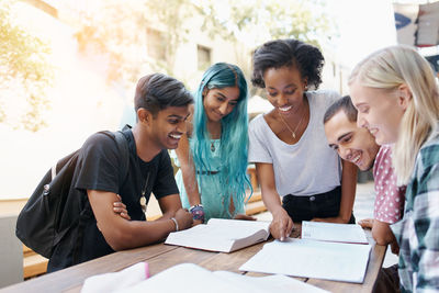 Cheerful friends studying at campus