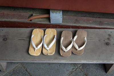 High angle view of wooden slippers on seat