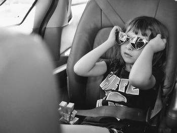 Portrait of cute girl sitting in bus