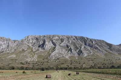 Scenic view of mountains against clear blue sky