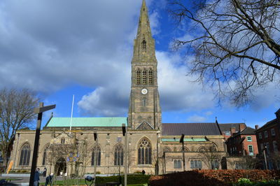 Low angle view of church against cloudy sky