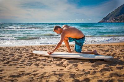 Full length of man on beach against sky