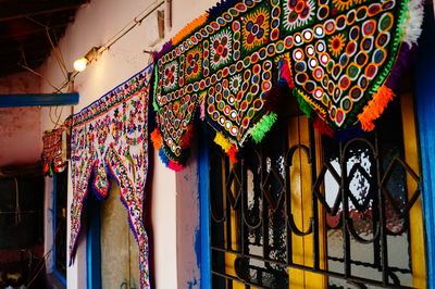 Multi colored decoration called as toran hanging on the entrance of home. 