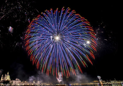 Low angle view of firework display at night