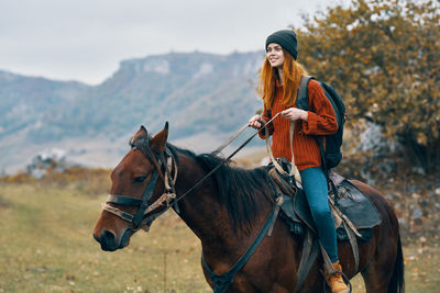 Young woman riding horse