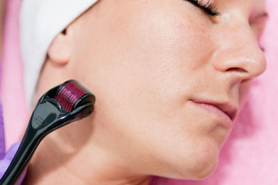 Close-up of woman massaging face