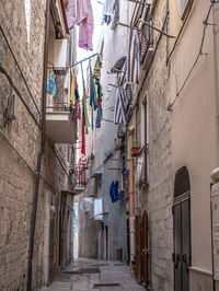 Low angle view of narrow alley amidst buildings