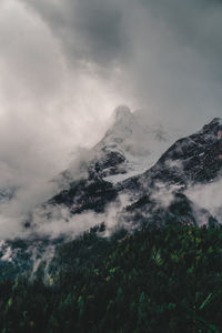 Low angle view of snowcapped mountains against sky