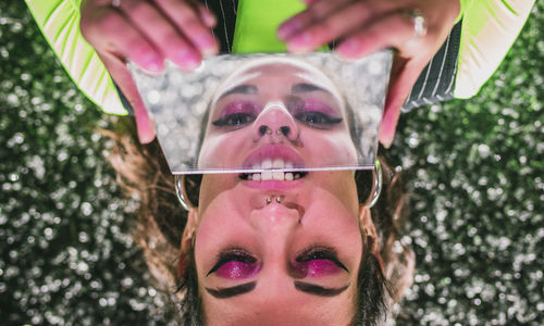 Close-up of woman carrying mirror in mouth