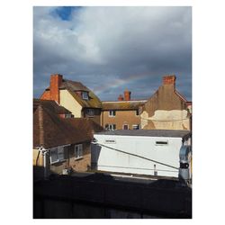 Buildings in town against sky
