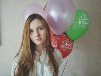 Portrait of young woman with balloons