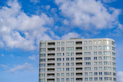 Low angle view of building against cloudy sky