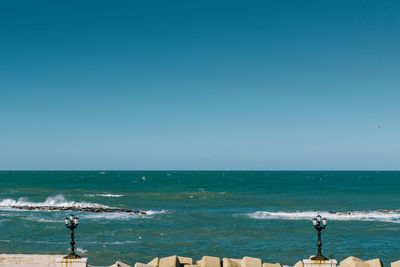 Scenic view of sea against clear blue sky