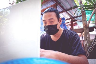 A man with a mask working on a marble table. because you need to keep your distance after the virus