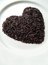 High angle view of coffee beans on white background