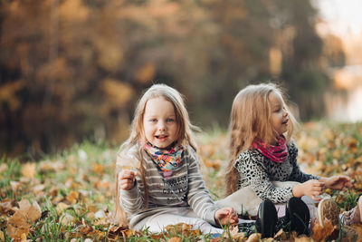 Girl sitting in park during autumn