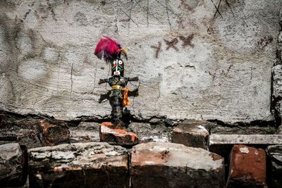 Low angle view of voodoo doll on wall