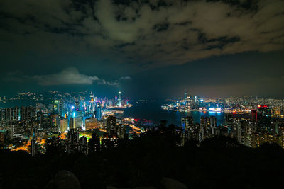 High angle view of illuminated city against sky at night