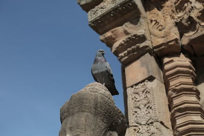 Low angle view of statue against sky