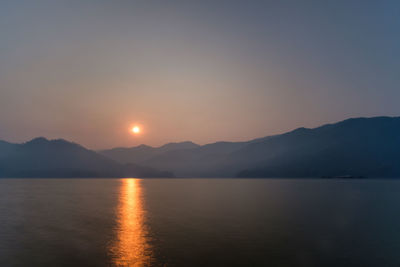 Scenic view of lake against sky during sunset