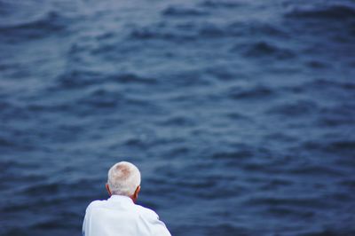Rear view of man looking at sea