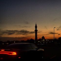 Traffic on road at sunset