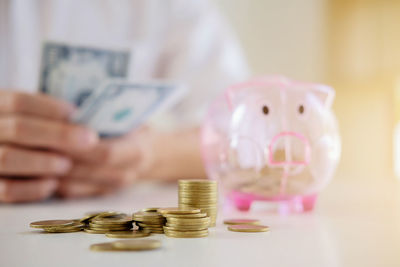 Midsection of business person counting money in office