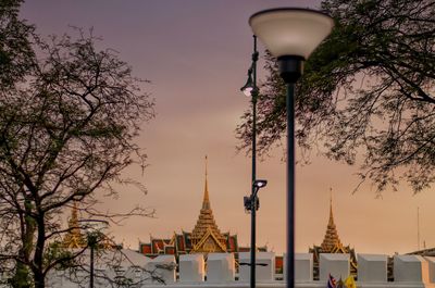 Street light by building against sky