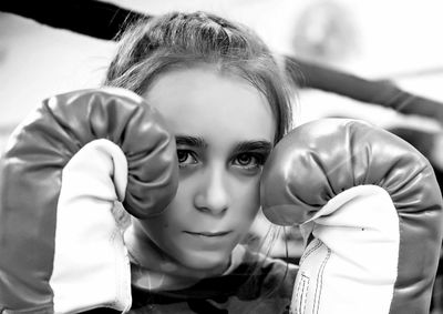 Close-up portrait of girl with boxing gloves