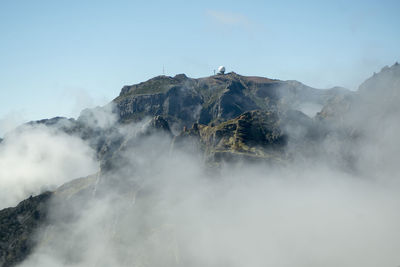 Smoke emitting from volcanic mountain against sky