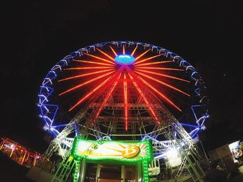 Low angle view of ferris wheel against sky at night