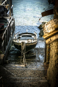 Old boat moored on sea shore