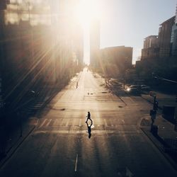 Empty road along buildings