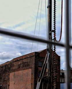 Low angle view of sailboat on building against sky