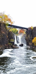 Scenic view of waterfall against sky