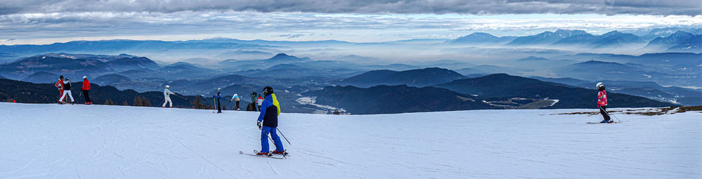People skiing on snow covered mountain