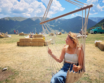 Girl on luxurious swing at mountain restaurant