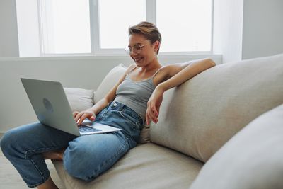 Young woman using laptop at home