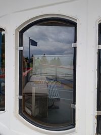 Reflection of sky on glass window of train