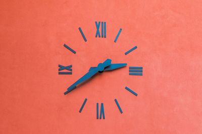 Clock on orange wall