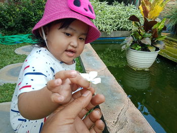 Portrait of woman holding baby in water