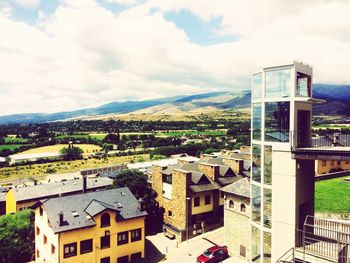 Houses against cloudy sky