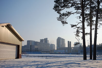 Buildings in city against clear sky